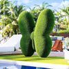 Luxury artificial turf butterfly topiary sculpture in a curated estate garden