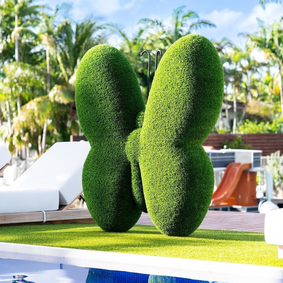Luxury artificial turf butterfly topiary sculpture in a curated estate garden