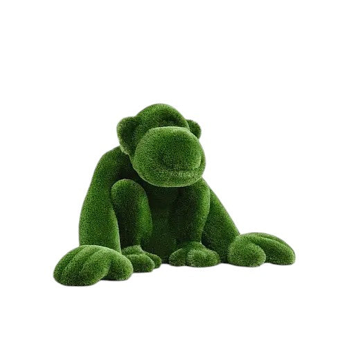 Jubilant, a large seated monkey topiary sculpture in artificial grass, posed with hands on the ground as part of the Guardians Collection.