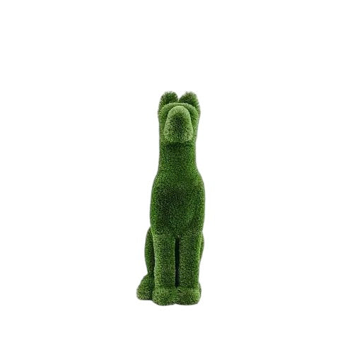 Loyal, a life-size dog topiary sculpture in artificial grass, seated upright in a protective posture from the Guardians Collection.