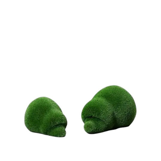 Thistle, a life-size hedgehog topiary sculpture in artificial grass, posed in a rounded, grounded form from the Grace Collection.