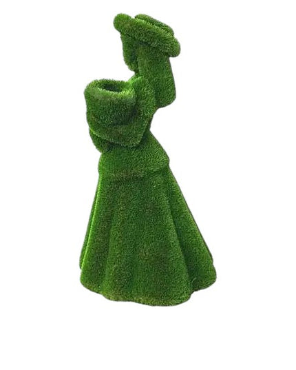 Topiary sculpture of flower girl wearing a summer hat and holding a bouquet, made of artificial grass

