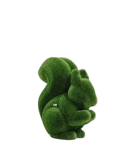 Wisp, a life-size squirrel topiary sculpture in artificial grass, posed in a moment of still curiosity from the Grace Collection.
