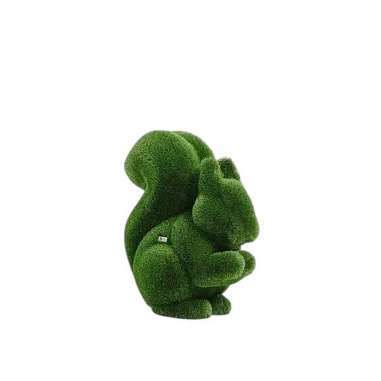 Wisp, a life-size squirrel topiary sculpture in artificial grass, posed in a moment of still curiosity from the Grace Collection.
