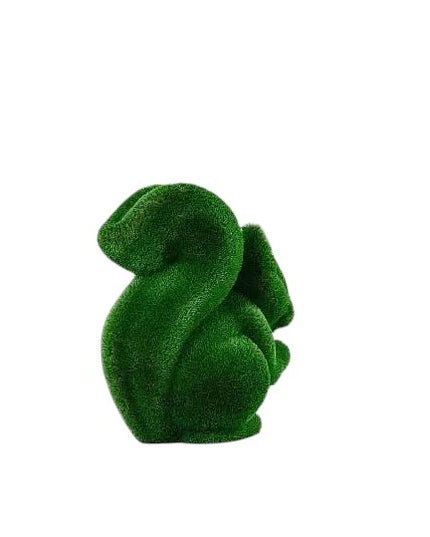 Wisp, a life-size squirrel topiary sculpture in artificial grass, posed in a moment of still curiosity from the Grace Collection.