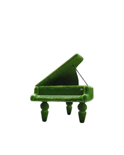 Sculptural grand piano wrapped in artificial grass, designed as a luxury statement piece

