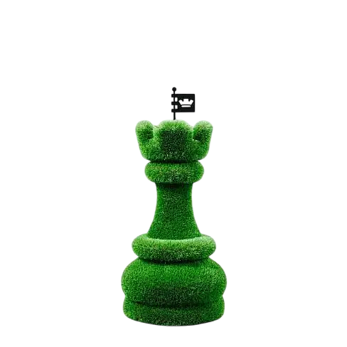 Oversized topiary chess sculptures made of artificial grass, including individual rook castle piece.

