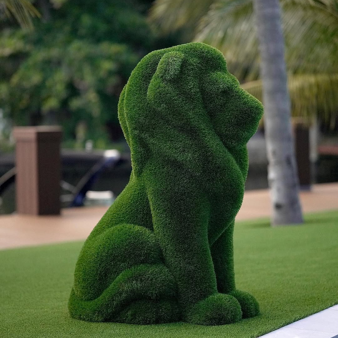 Luxury animal topiary sculpture of a seated lion, handcrafted in lush artificial greenery for high-end landscape design