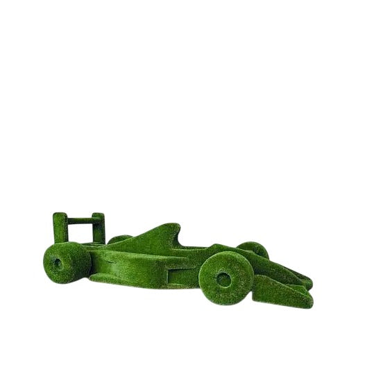 Life-size F1 car sculpture wrapped in artificial grass, designed as a botanical performance piece

